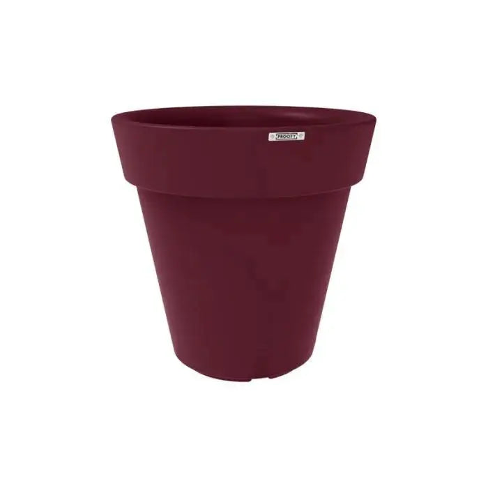 Mise en situation du vase Héritage avec végétation luxuriante